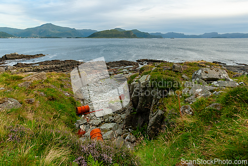 Image of Tranquil coastal landscape with rocky shorelines and vibrant gre