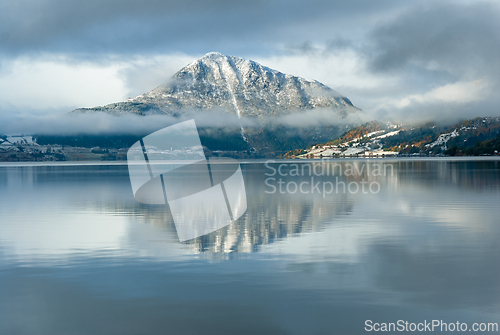 Image of Enchanting winter landscape featuring a snow-capped mountain ref