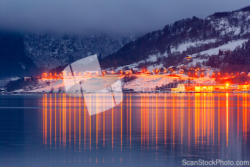 Image of Twilight reflection of a snow-covered mountain village shimmerin