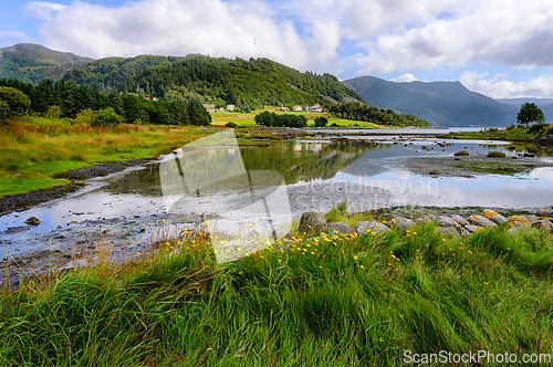 Image of Tranquil morning by the serene bay, surrounded by lush mountains