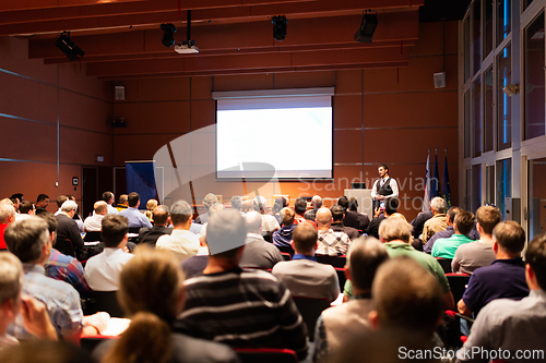 Image of Business speaker giving a talk at business conference meeting event.