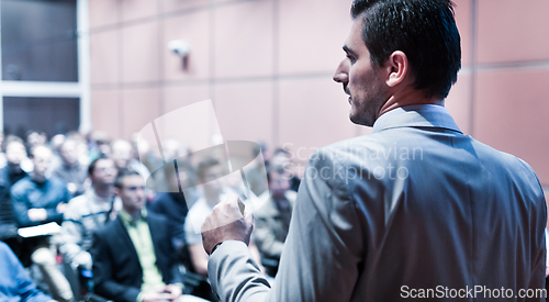 Image of Public speaker giving talk at business event.