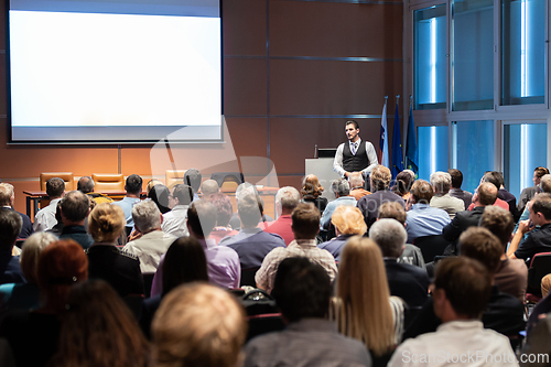 Image of Business speaker giving a talk at business conference meeting event.