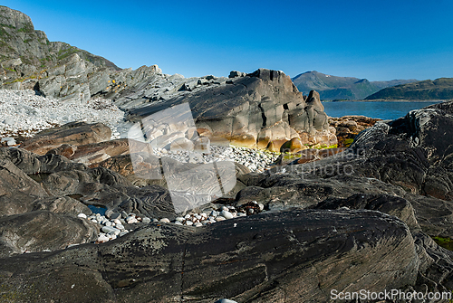 Image of Serene coastal landscape at low tide revealing unique rock forma