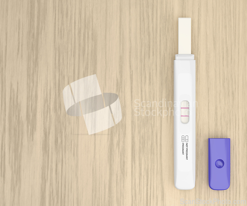 Image of Pregnancy test on a wooden desk