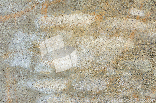 Image of A close-up view of a gray concrete wall with white paint splatte