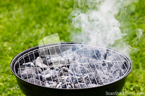 Image of empty hot grill with smoke