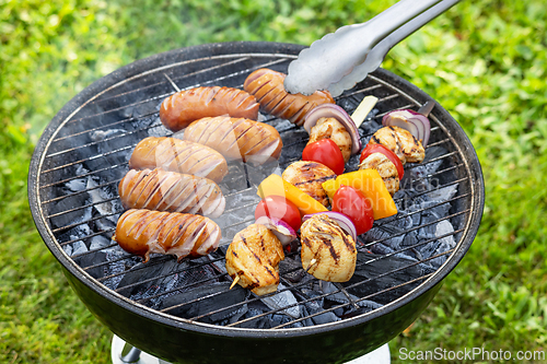 Image of grilled sausages and chicken skewers