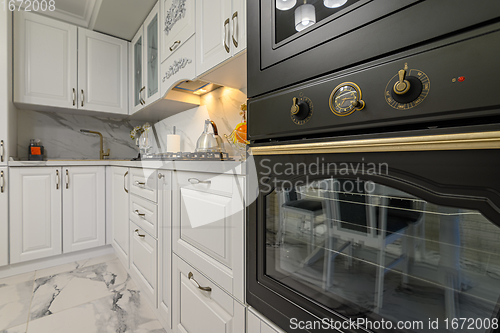 Image of White kitchen in classic style, front view
