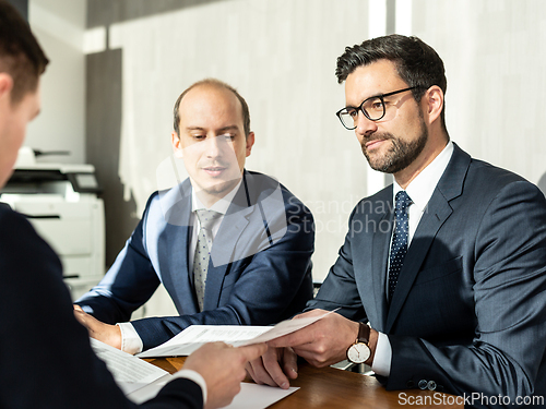 Image of Close-up Of Businessperson Signing Contract,woman writing paper at the desk with pen and reading books at table with basic business Form document working in office