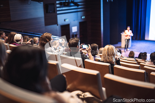 Image of Woman giving presentation on business conference event.