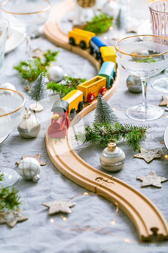Image of Traditional festive place setting for Christmas, decorated with wooden railways