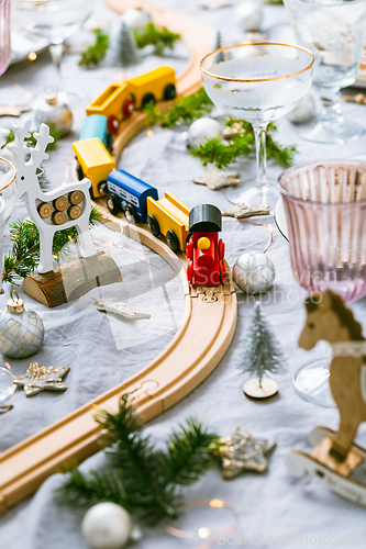 Image of Traditional festive place setting for Christmas, decorated with wooden railways