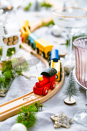Image of Traditional festive place setting for Christmas, glasses of sparkling wine