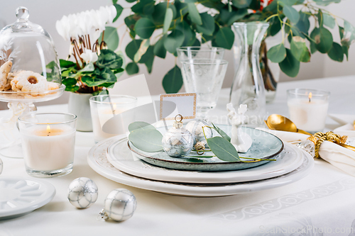 Image of Traditional festive place setting for Christmas, decorated with eucalyptus branch
