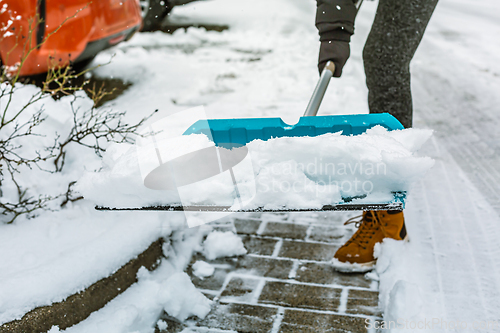Image of Removing snow from sidewalk, snow shoveling 