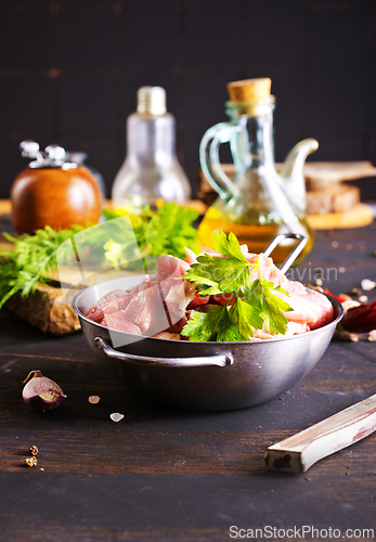 Image of raw meat in metal bowl, meat and herb and spices