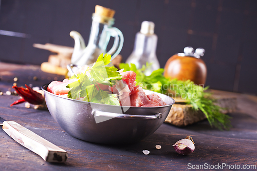 Image of raw meat in metal bowl, meat and herb and spices