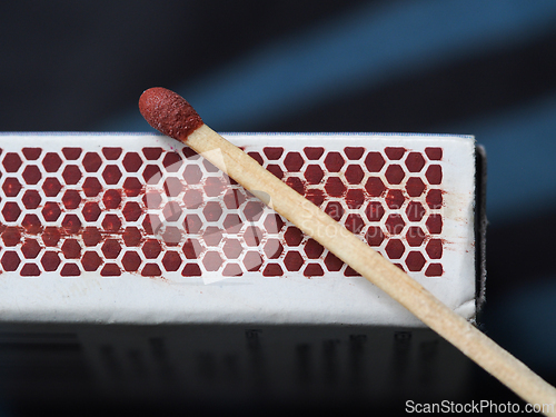 Image of A match and the side of a  match box