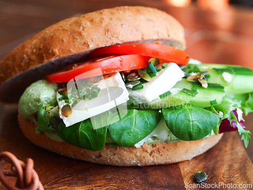 Image of Bagel with cheese and vegetables