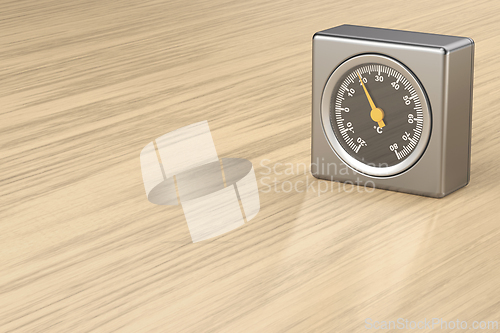 Image of Silver thermometer on wooden desk