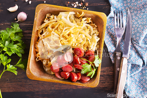 Image of A bowl with Bratwurst and Sauerkraut as side dish - traditional German food