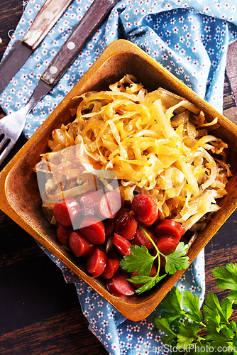 Image of A bowl with Bratwurst and Sauerkraut as side dish - traditional German food
