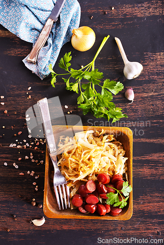 Image of A bowl with Bratwurst and Sauerkraut as side dish - traditional German food
