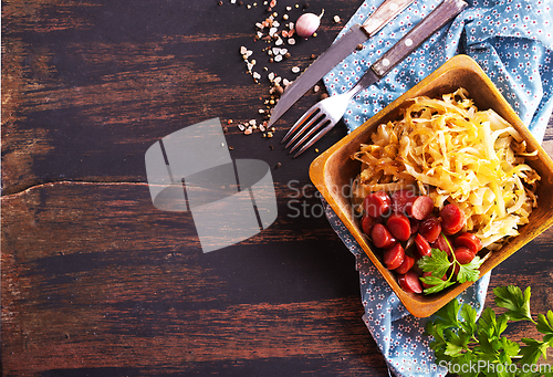 Image of A bowl with Bratwurst and Sauerkraut as side dish - traditional German food