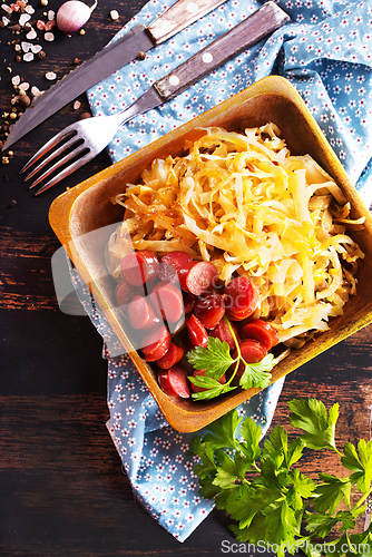 Image of A bowl with Bratwurst and Sauerkraut as side dish - traditional German food
