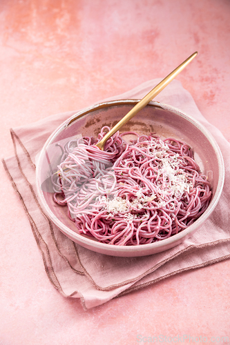 Image of Homemade pink pasta with garlic, lemon and parmesan, naturally colored by red cabbage