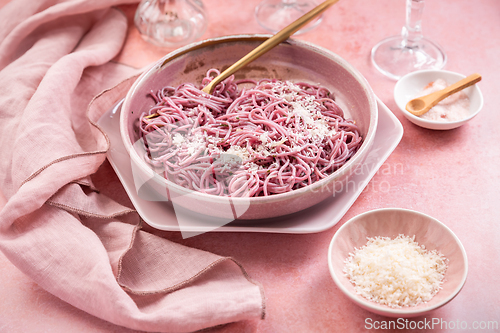 Image of Homemade pink pasta with garlic, lemon and parmesan, naturally colored by red cabbage