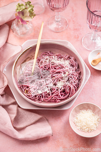 Image of Homemade pink pasta with garlic, lemon and parmesan, naturally colored by red cabbage