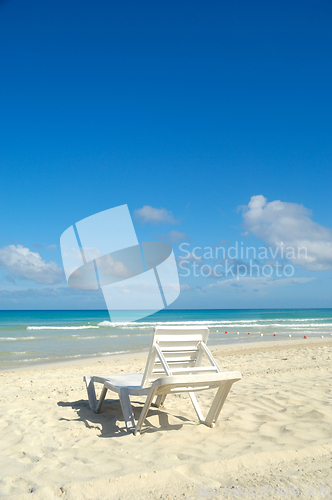Image of sunbeds and costline  at tropical beach