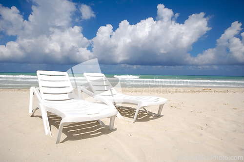 Image of sunbeds and costline  at tropical beach
