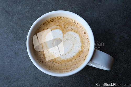 Image of A cup with a caffe latte on a table