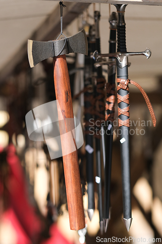 Image of Axe and short swords hanging at a medieval market