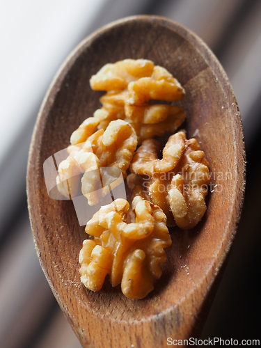 Image of Walnuts on a wooden spoon