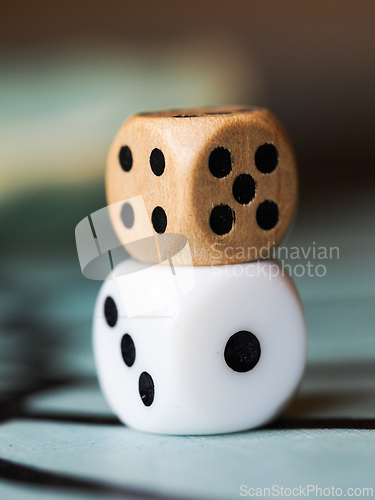 Image of One plastic and one wooden die