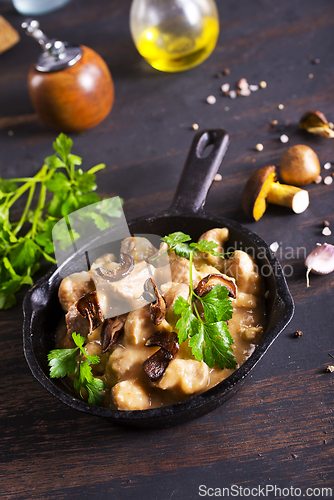Image of meat stew with mushrooms in cream sauce in pan