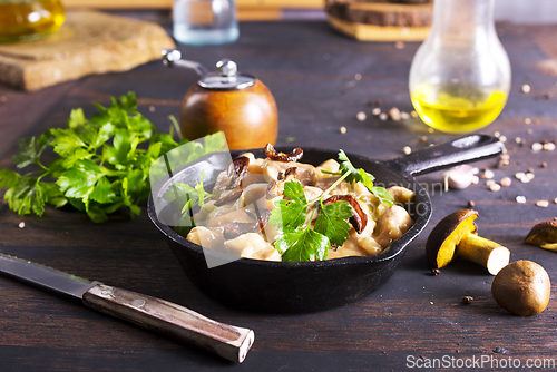 Image of meat stew with mushrooms in cream sauce in pan
