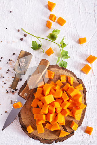 Image of raw pumpkin cubes on board