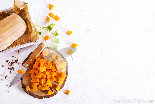 Image of raw pumpkin cubes on board