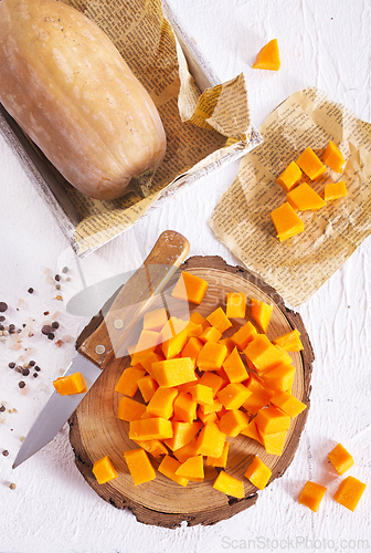 Image of raw pumpkin cubes on board