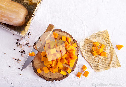 Image of raw pumpkin cubes on board