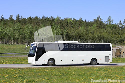 Image of White Bus on Summer Freeway