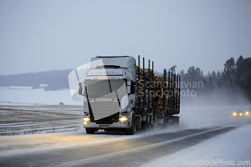 Image of Logging Truck on Snowy Winter Highway