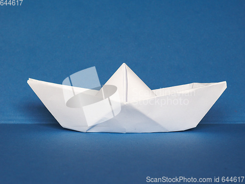 Image of paper boat over blue
