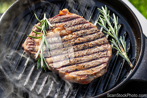 Image of beef steak on grilling pan