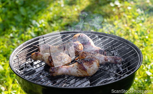 Image of chicken legs on a grill